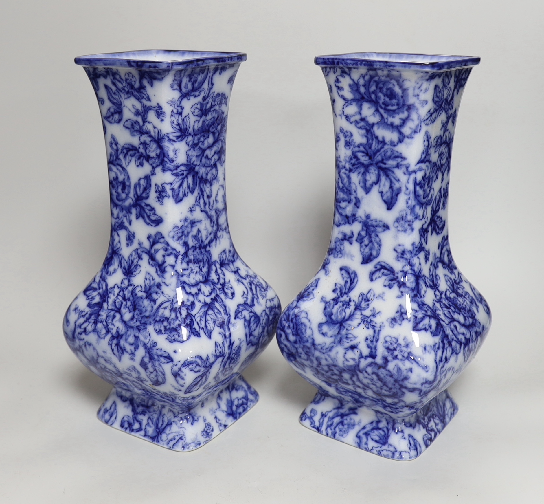 A pair of Losol ware blue and white vases, a slipware jug, a faience candle holder and a Chinese tea canister (without cover), vases 33cm high